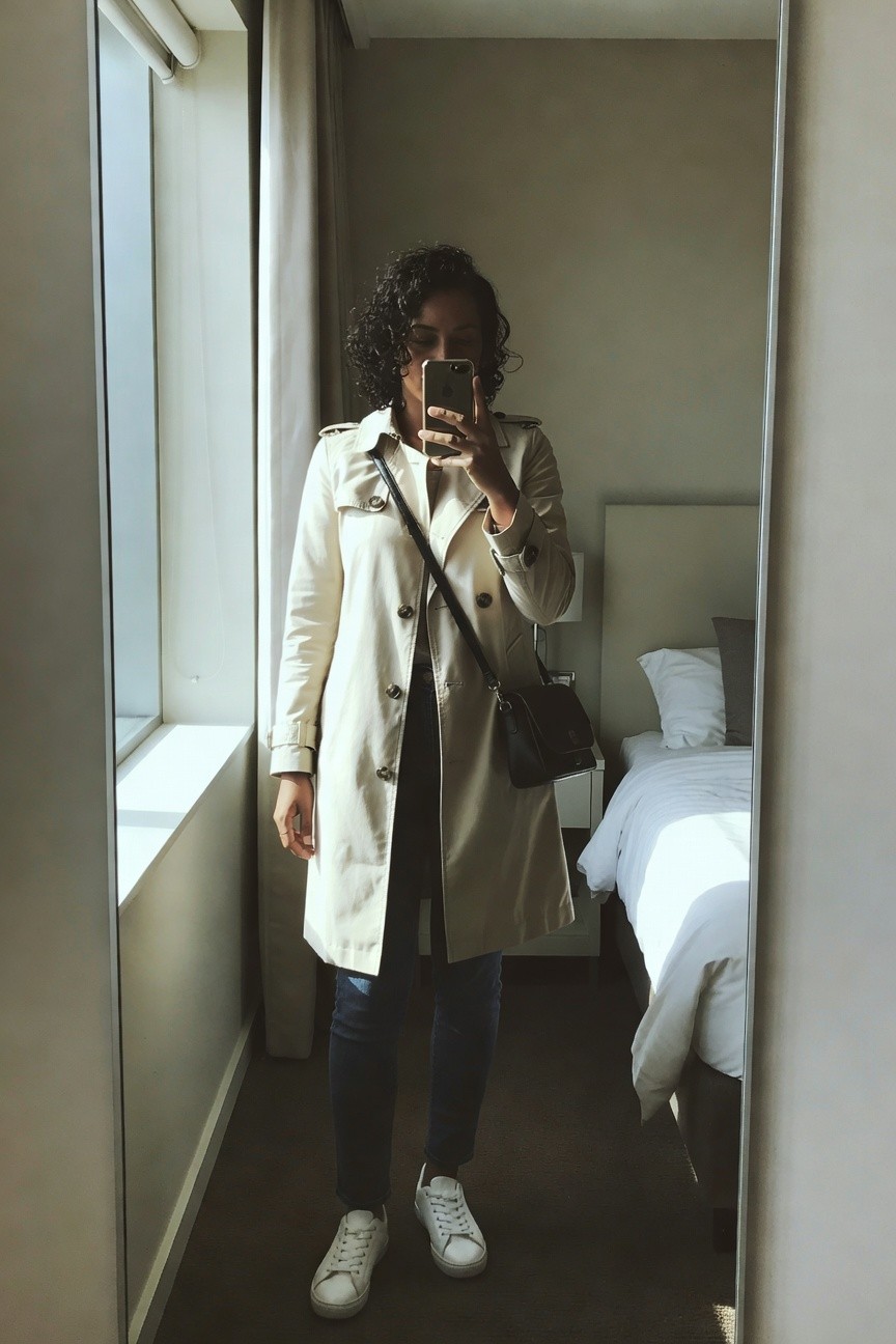 Trench Coat Over Jeans And White Sneakers