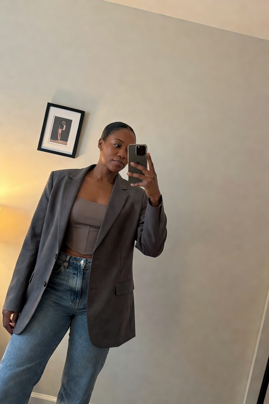 Blazer Layered Over Crop Top And Jeans