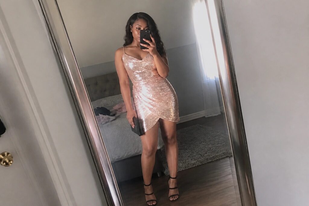 22 Birthday Outfits for Black Women That Stand Out in Every Photo Woman in rose-gold sequin mini dress taking bedroom mirror selfie with phone